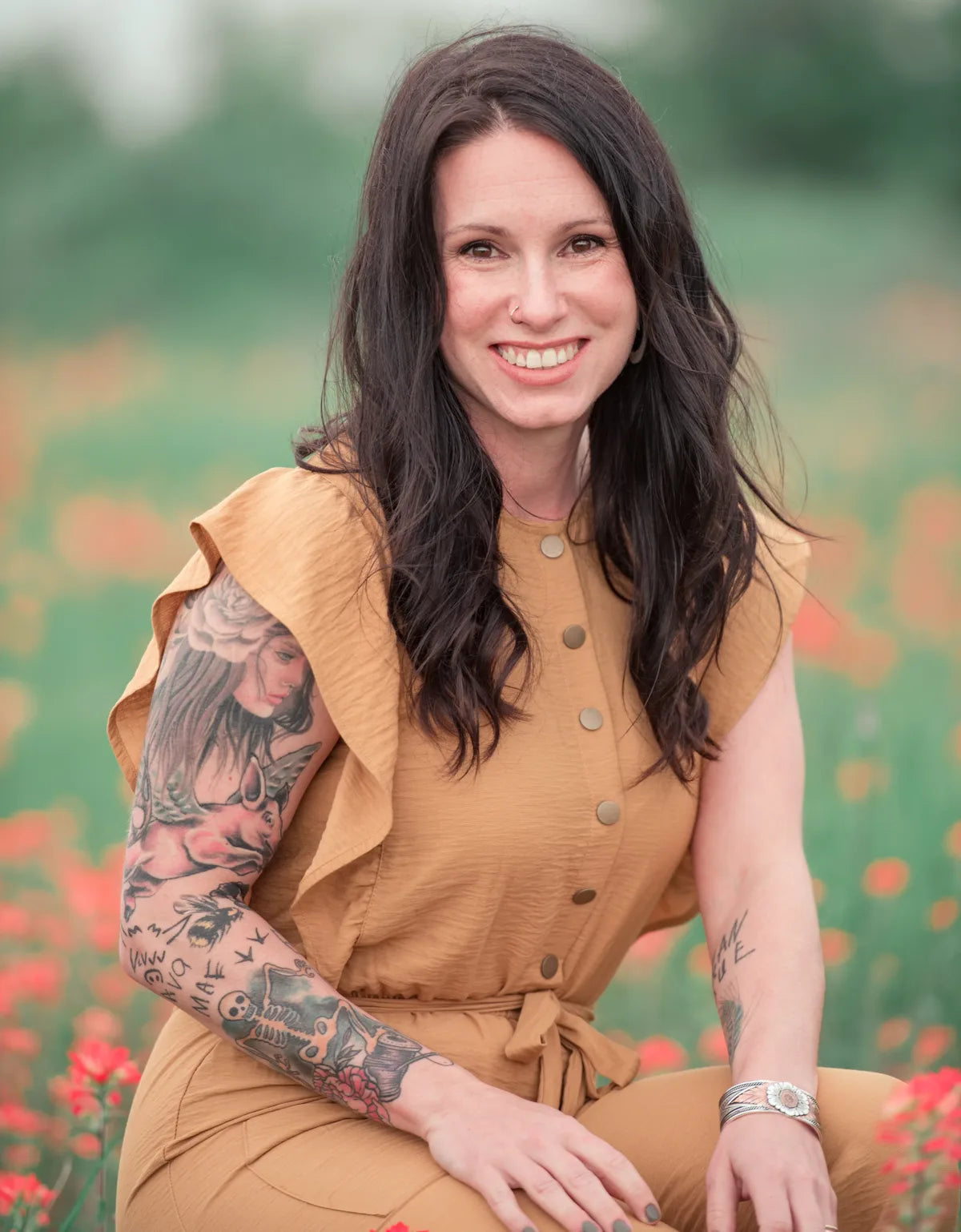 Brandi Barker, owner of Downtown Crafting, smiling in a field of wildflowers
